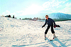 A foreign tourist enjoys skiing