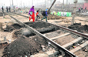 Digging work to lay the foundation and construction of suporting pillars along the railway tracks for the ROB in place of Lakkar bridge commences in Ludhiana on Monday. Tribune photo: Himanshu Mahajan