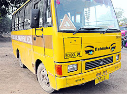 The name of the school is missing on the front end of a bus