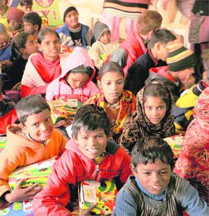 Rag-pickers are all smiles after receiving education kits from the Deputy Commissioner in Karnal on Tuesday. The function was organised by Bal Bhawan. 