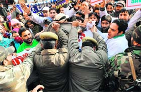 Policemen jostle with protesting contractual employees in Srinagar on Tuesday