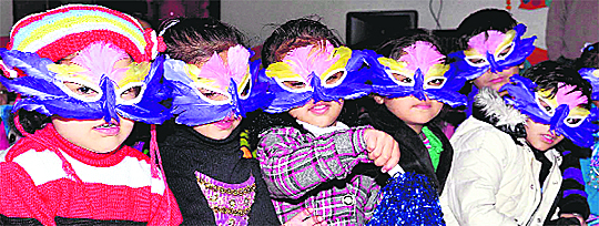 Students celebrate New Year with a mask party at St Soldier Kids Paradise on Kapurthala road in Jalandhar on Tuesday.