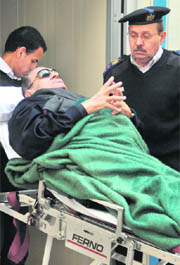 Egyptian ex-President Hosni Mubarak leaves the courtroom on a gurney bed in Cairo. 
