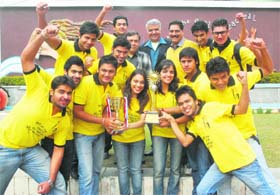 Students pose with the trophy won during the IIT-Mumbai fest, on the campus of DAV College at Sector 10 in Chandigarh on Wednesday