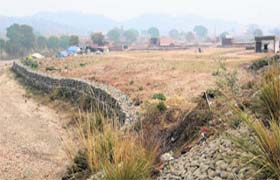 A stone crate wall raised in Patiala Ki Rao to divert the flow of seasonal rivulet near Nadha village