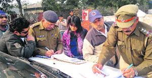 Traffic policemen challan traffic rule violators in Hisar on Wednesday. 