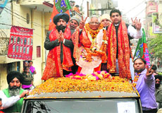 BJP candidate from the Jalandhar (West) constituency Bhagat Chunni Lal moves out in an open vehicle in Jalandhar on Wednesday. 