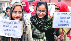 Visually-impaired girls take part in a rally to mark World Braille Day in Srinagar on Wednesday