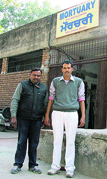 Dharampal and Pal (right) strike a pose in front of a mortuary of Lord Mahavira Civil Hospital in Ludhiana