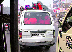 An overcrowded school van carries school children in Ludhiana