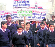 School students take part in a rally during the National Road Safety Week in Rajpura on Wednesday
