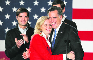 Republican presidential candidate and Massachusetts ex-Governor Mitt Romney hugs his wife Ann as he appeared at his Iowa Caucus night rally in Des Moines.