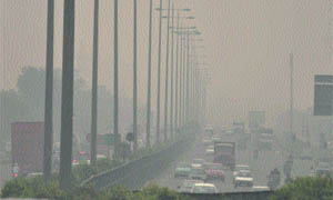 Vehicles move through fog in Gurgaon. 