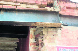 A beam juts out of a portion of the entrance gate of the Old Grain Market, Jagraon. 