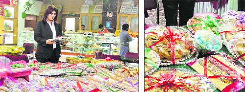 A woman checks out gift packs for Lohri; and (right) “Gachak” in different flavours on display ahead of the festival in Ludhiana.