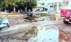 Water accumulated in front of shops due to the absence of a drainage system at a newly constructed market