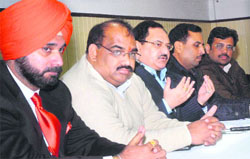 BJP national secretary JP Nadda (centre) addresses party nominees in Jalandhar on Thursday. On the extreme left is Navjot Singh Sidhu. 