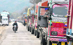 Trucks stranded on the national highway near Nagrota due to heavy snowfall in the region on Friday.
