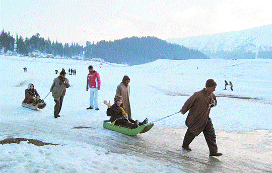 Tourists enjoy a ride on toboggans at the Gulmarg Ski Resort in Kashmir