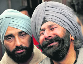 Gurmohan Singh wails over his sons death in an accident in Ludhiana on Friday.