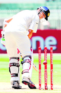 Rahul Dravid looks back to see that he has been bowled by Australian paceman James Pattinson on the fourth day of the first Test match between Australia and India at Melbourne