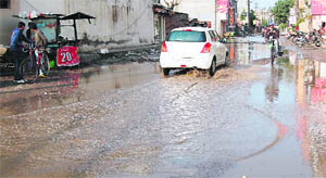 A waterlogged road after rain in Amritsar on Saturday. 