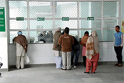 Patients taking OPD slips from a registration counter at the Civil Hospital in Bathinda on Saturday