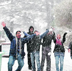 Tourists enjoy fresh heavy snowfall in Shimla on Saturday. 