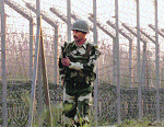 A BSF jawan patrols the  border in the Kanachak sector in Jammu. 