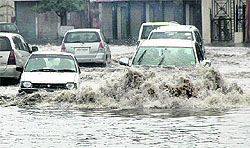 Vehicles move on a waterlogged road