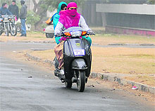 Girls brave the chill while riding a scooter in Ludhiana