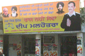 EC directions notwithstanding, Deep Malhotra is using liquor shops to put up hoardings to seek votes.