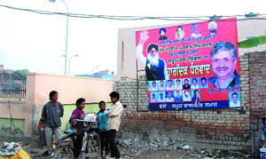 A poster of SAD candidate from Bathinda (Urban) hung on the wall of a building at Dhobiana Basti in complete violation of the election code of coduct. 