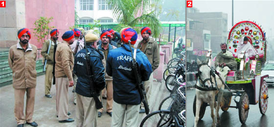 1. Braving the chill, the traffic police and cops carry out their duty in Bathinda on Sunday. 2. Life has to keep moving and the chariot rider takes his light four-wheel horse-drawn ceremonial carriage to its destination.