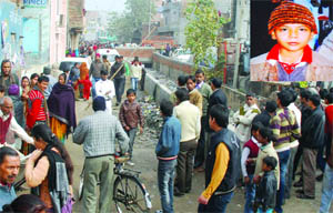 Residents gather around a sewer in the Usmanpur area in east Delhi where the body of a 10-year-old boy, Salim (inset), was found on Sunday. 