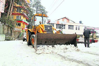 A road being cleared of snow in Shimla on Sunday.