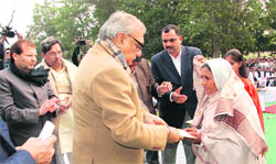 Chief Minister Bhupinder Singh Hooda honours a war widow during a programme organised by the Panipat Foundation on Saturday. 