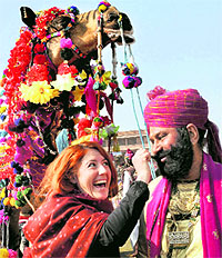 A foreigner admires the long moustache of a Rajasthani man during the Camel Festival in Bikaner on Sunday