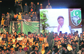 Pervez Musharraf addresses activists of the All Pakistan Muslim League from Dubai through a video link during a public meeting in Karachi on Sunday.