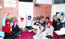 GND varsity teachers sit on a dharna outside the office of the Registrar on the varsity campus on Monday. 