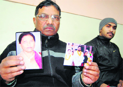 Mathias shows picture of his sister to mediapersons in Amritsar on Monday.