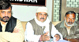 State chief of the Janata Dal (United) Pramod Sharma (centre) announces the list of candidates in Haridwar on Monday.