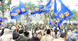 Supporters of the Bahujan Samaj Party wave flags outside the electoral office in Haridwar on Monday.