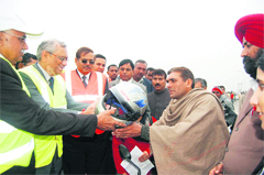 Vice-Chancellor of Deenbandhu Chhotu Ram University of Science and Technology, Murthal, HS Chahal and technical member of the National Highways Authority of India VP Patkar hand over a helmet to a two-wheeler rider in Sonepat