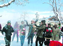 Winter revellers rejoice as they play with snow in Shimla on Monday. 