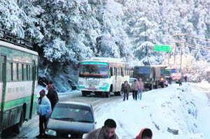 Vehicles stuck in a traffic jam due to snowfall at Tara Devi in Shimla on Monday. 