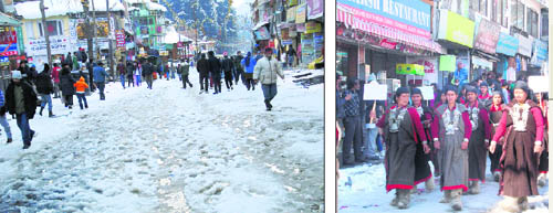 Tourists have a tough time on a slushy Mall during the inauguration of the five-day Winter Carnival in Manali on Monday; and (right) a procession being taken out by the mahila mandal of a remote village of the upper Kullu valley in Manali.