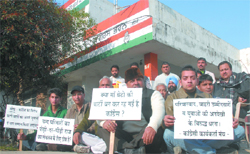 Adviser to the RTI Cell of the PPCC Anil Vashisth along with several other Congress men sits on a dharna in front of the office of the District Congress Committee in Jalanhdhar on Monday.