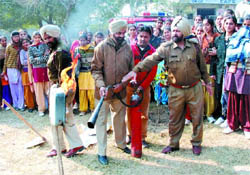 Officials of the fire brigade demonstrate the functioning of a fire-fighting equipment as the students look on during an NSS camp held at Government Rajindra College in Bathinda on Tuesday