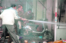 Firemen labour hard to douse flames at a chemist shop in Jalandhar on Tuesday. 